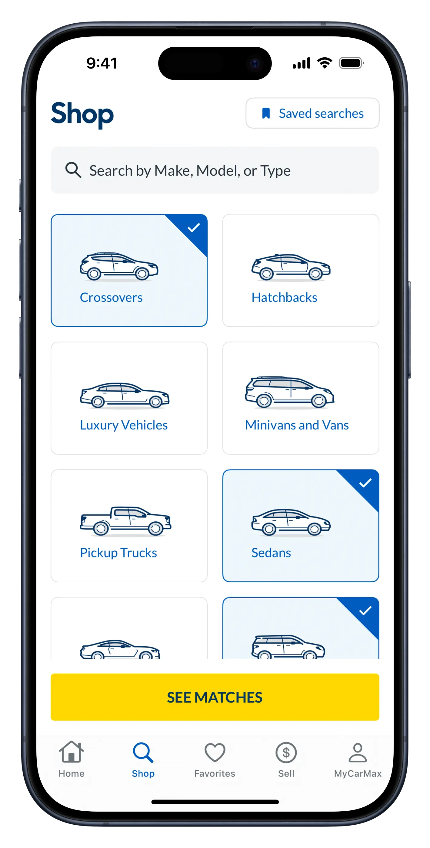 Screenshot of the CarMax app's 'Shop' screen, displaying a search bar in the navigation toolbar with a two-across grid of vehicle types beneath it. Crossovers, sedans, and SUVs are selected from the grid. A yellow action button appears at the bottom of the screen that reads 'See Matches'.